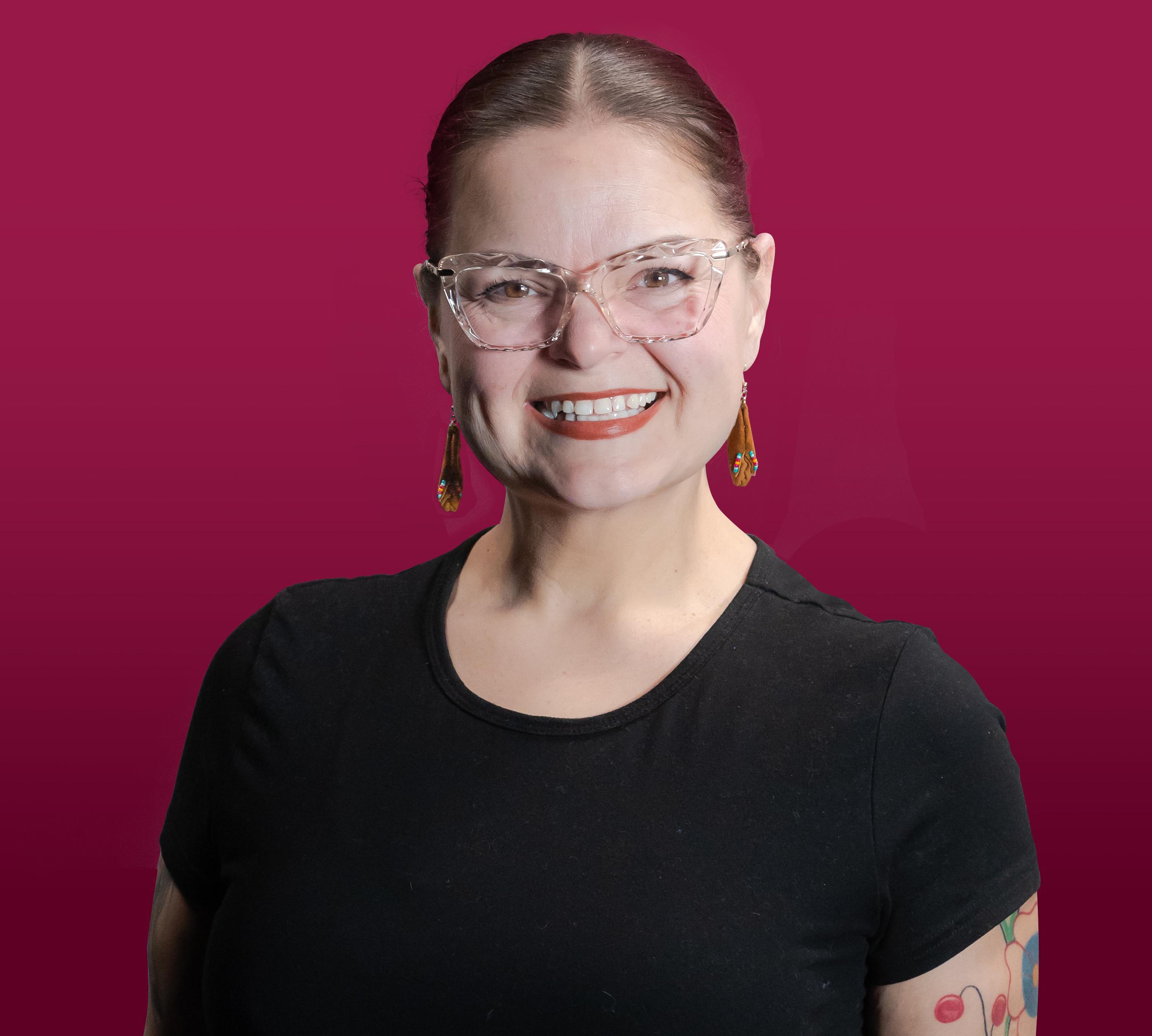 Ren Horst photographed against a maroon background.